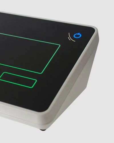 Close-up of a control unit with an illuminated capacitive button and green control markings