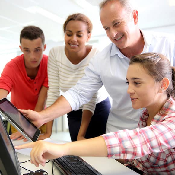 Group of employees looking at a screen together