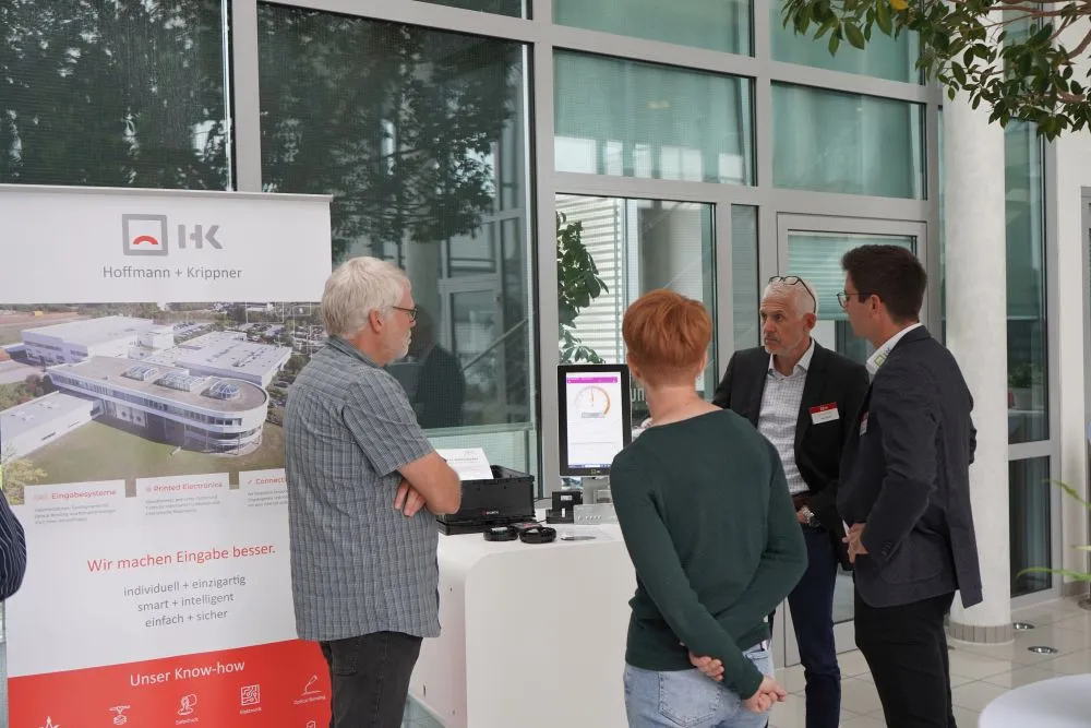 H+K Future Talk participants examine the products in the exhibition