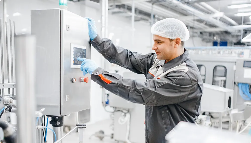 Man operates machine in production