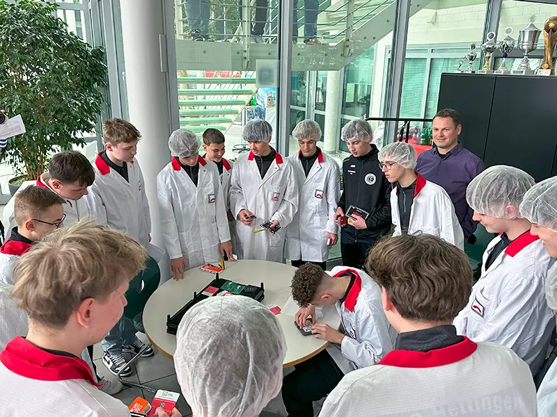 Group of young soccer players in ESD clothing get an explanation of the film structure