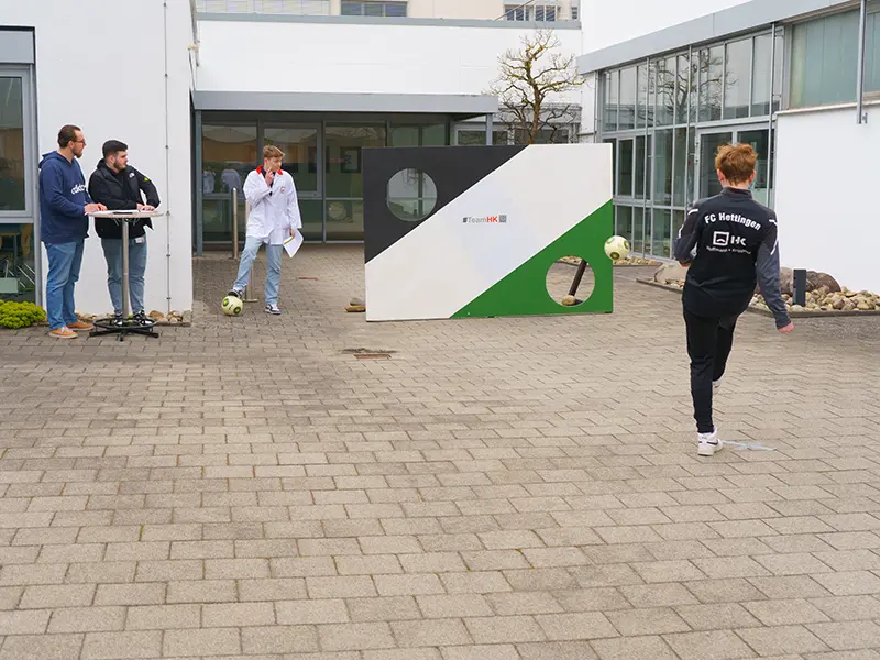 Boy shoots at goal wall