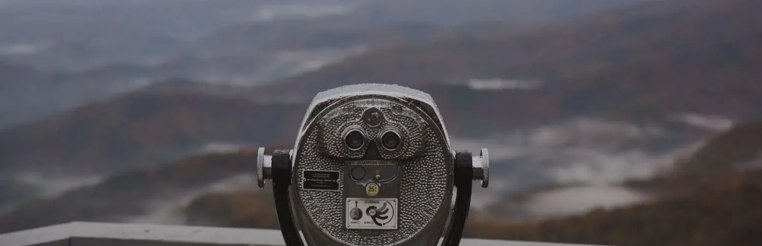 Binoculars with mountains in the background